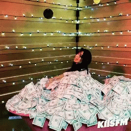 animated gif of a woman in a pile of money, throwing money