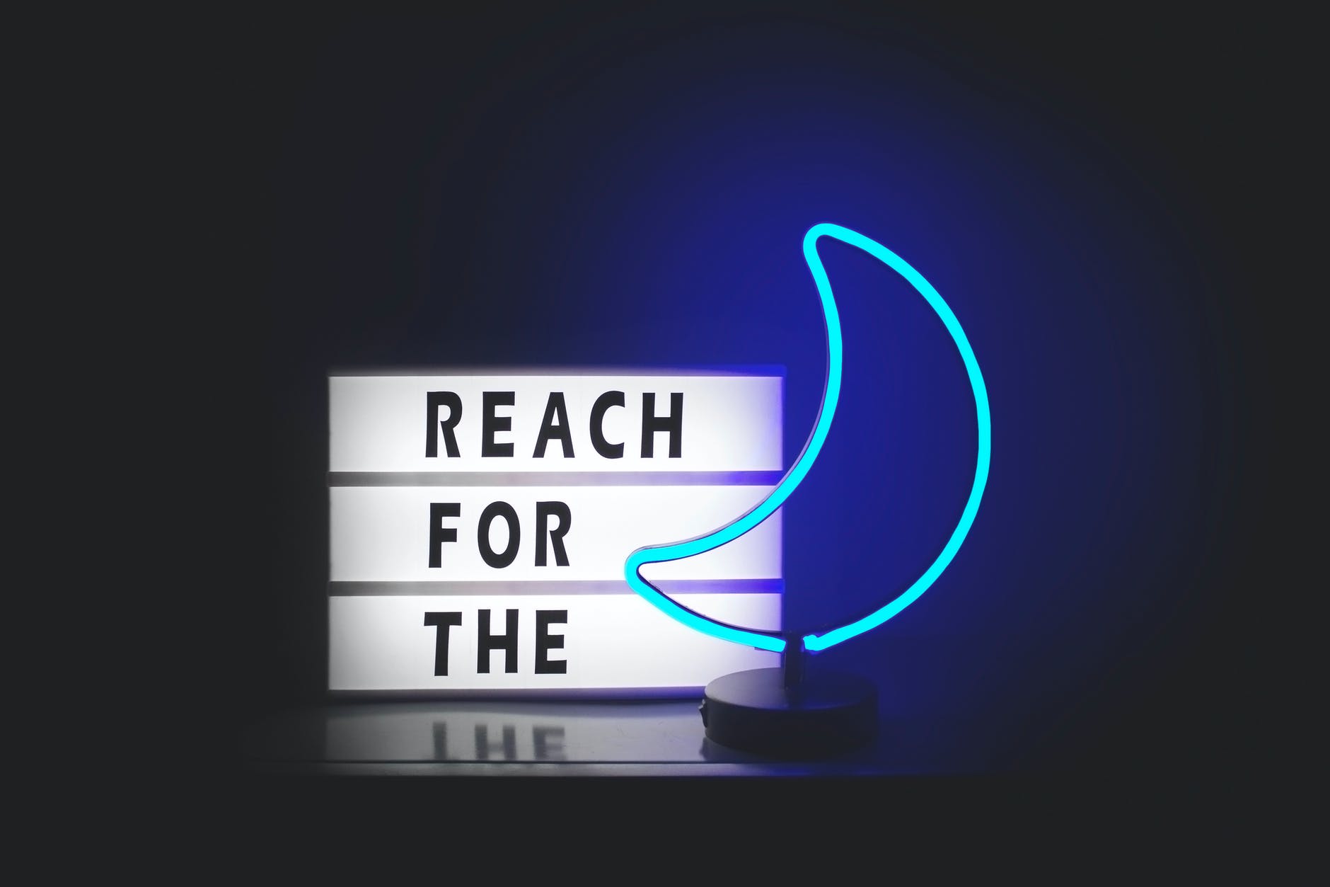photo of a "reach for the moon" sign