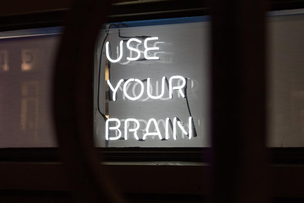 neon sign that says 'use your brain'