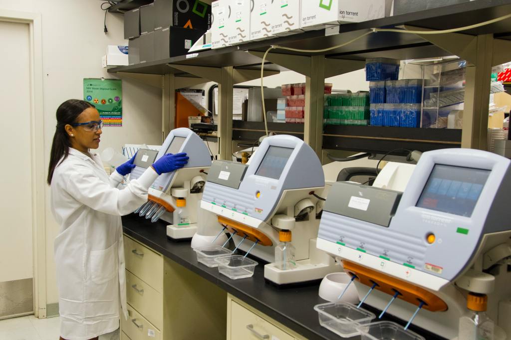 photo of a laboratory scientist working with lab equipment