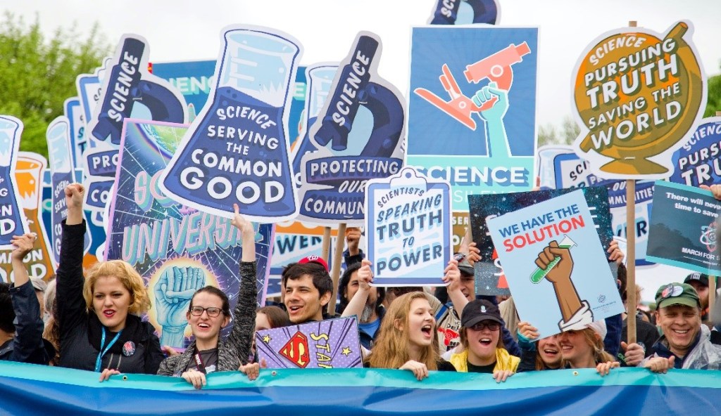 photo of people holding signs at a march for science rally