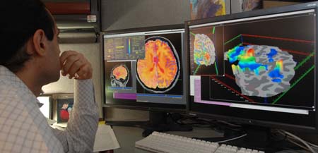 photo of a researcher looking at MRI scans