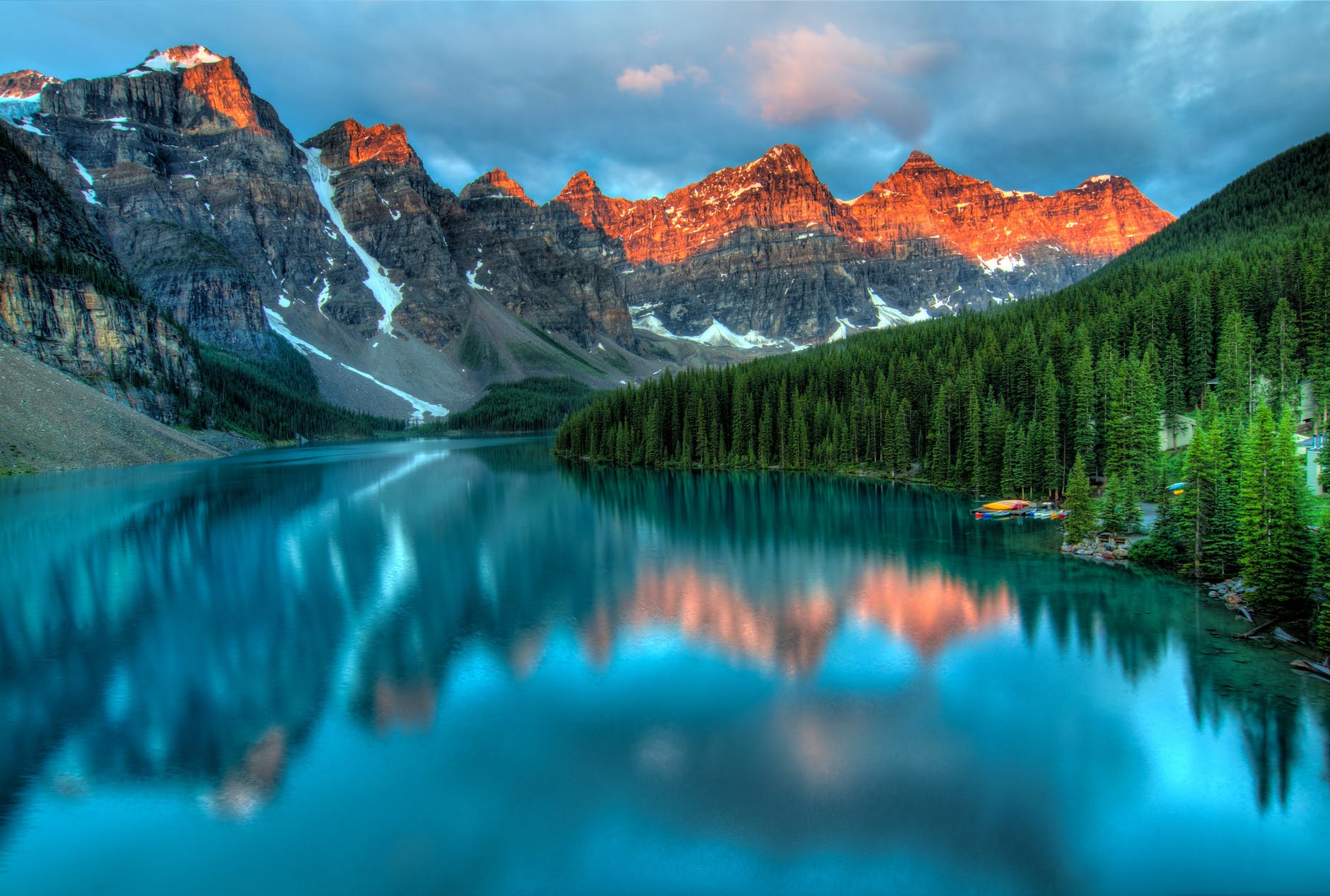 photo of a nature scene with a mountain range, trees, and a body of water