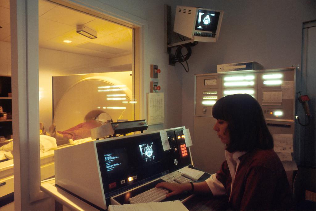 photo of woman operating a ct scanner at the national cancer institute