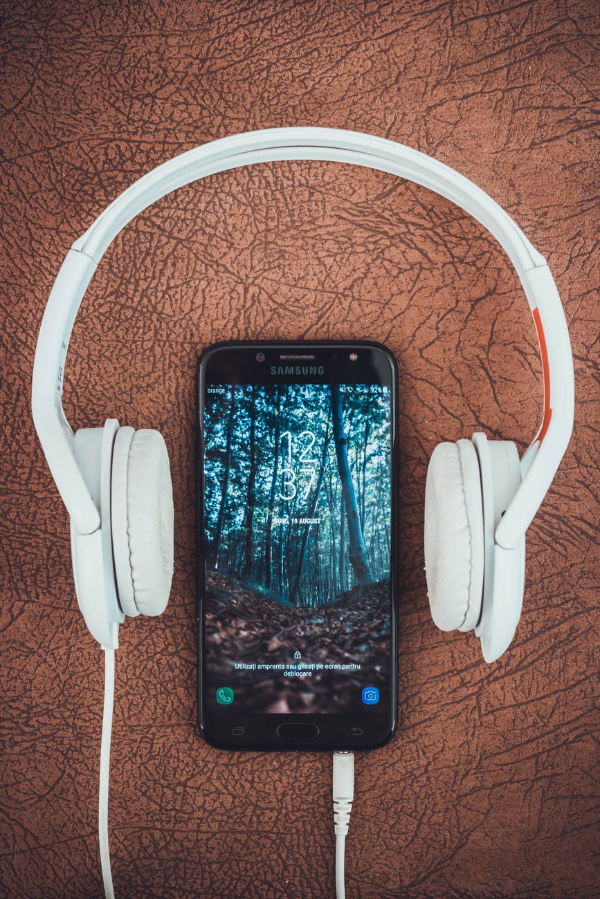 photo of a cell phone and headphones
