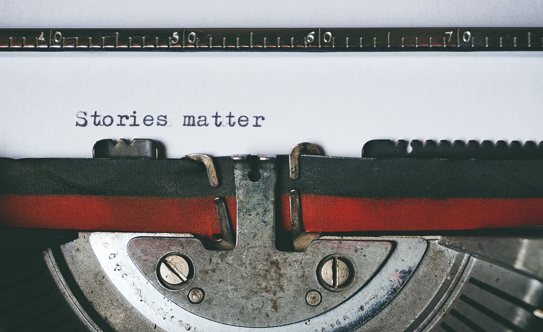 picture of a typewriter with the words "stories matter" typed out