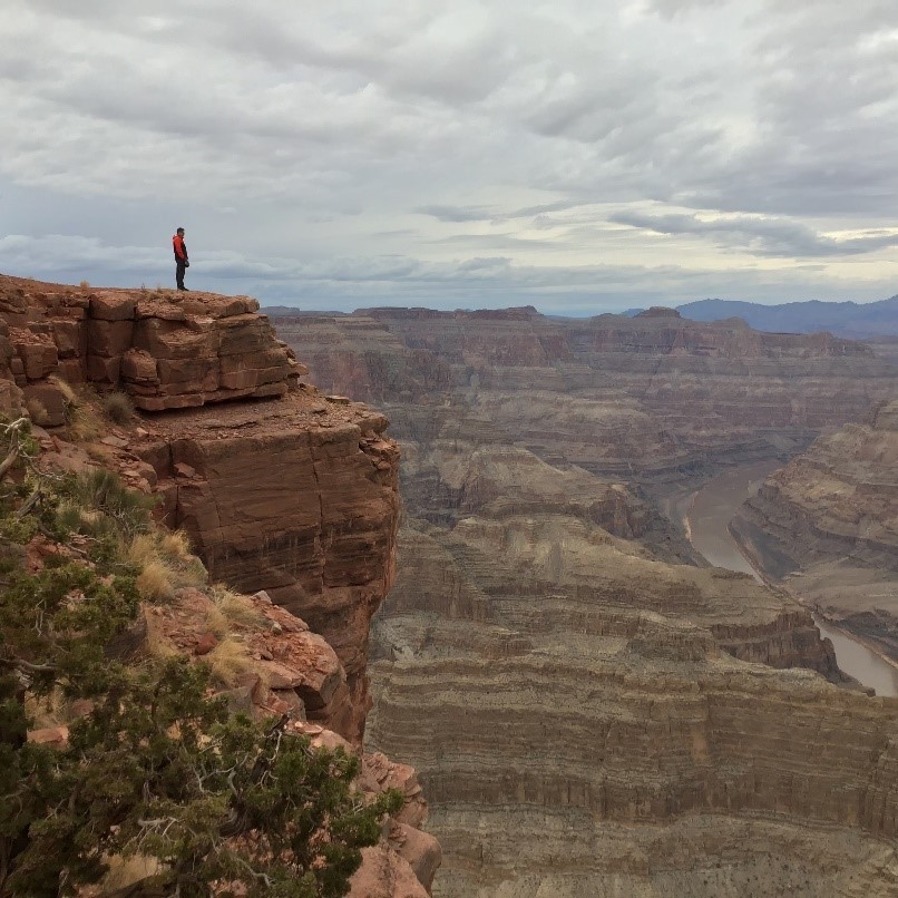 photo of a person looking at the mountains