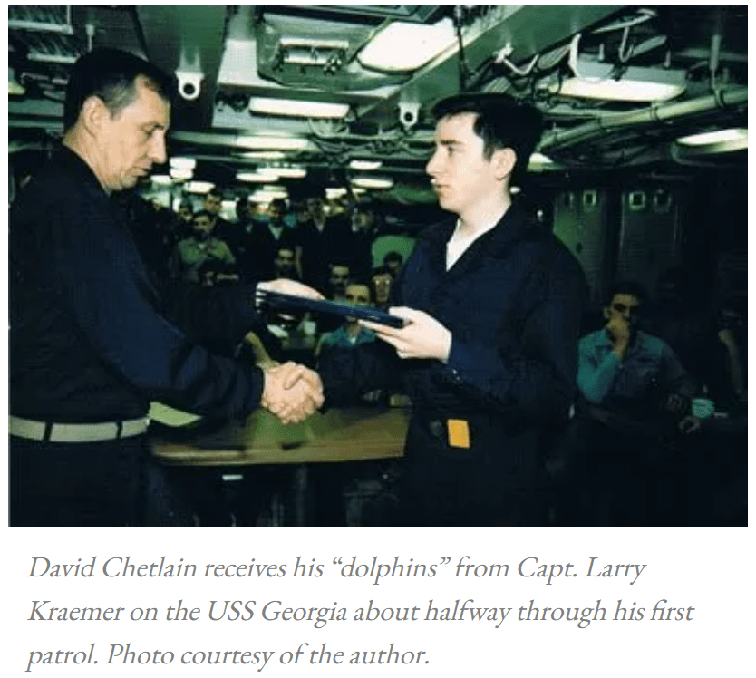 photo of david chetlain receiving his "dolphins" from capt. larry kraemer on the uss georgia about halfway through david's first patrol. photo courtesy of david chetlain. 
