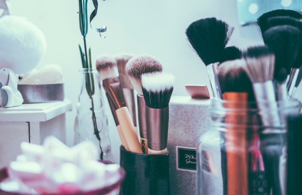 photo of makeup brushes in jars in a beauty room